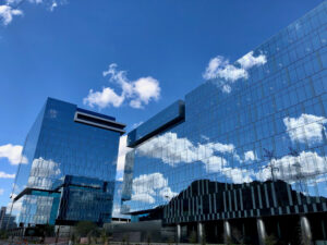 The State Farm office buildings reflecting the sky above them.